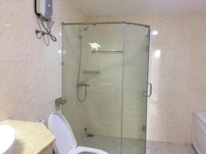 a glass shower in a bathroom with a toilet at Sơn Thịnh - Oasky Apartment in Vung Tau +43 photos