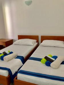 two beds in a room with towels on them at Lady Di in Nečujam