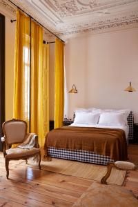 a room with a bed, chair and a lamp at Cocorico Luxury Guest House - Porto in Porto
