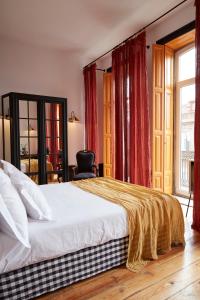 a hotel room with a bed and a dresser at Cocorico Luxury Guest House - Porto in Porto