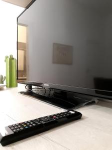 a television sitting on a table with a remote control at O lastraco in Trapani