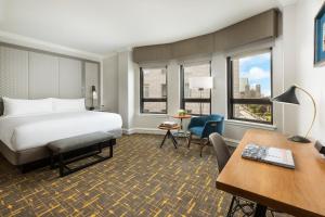 a hotel room with a bed and a desk at Stanford Court San Francisco in San Francisco +49 photos