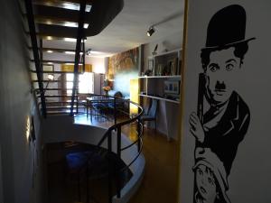 a living room with a painting of a man on the wall at 2 Balcones a la Hoz in Cuenca