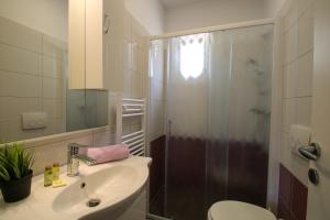 a bathroom with a shower and a sink and a toilet at Apartments Supra Mare in Rabac +39 photos