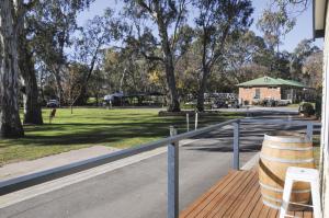 a park with a fence and a field with trees at Euroa Caravan Park in Euroa