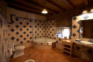 a bathroom with a tub and a toilet and a sink at Areal in Viveiro