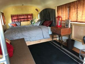 a bedroom with a large bed and a table at Klutina Kate's B&B in Copper Center