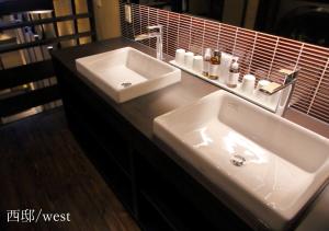 a bathroom with a white sink and a mirror at Houka in Kyoto +54 photos