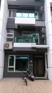 a motor scooter parked in front of a building at Smile Castle in Luodong