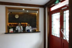 two women in a mirror in a restaurant at Beijing Downtown Travelotel in Beijing