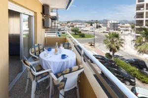 a table on a balcony with a view of a street at River in Daimuz