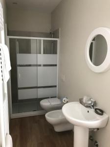 a bathroom with a toilet and a sink and a shower at Casa Patrizia in Gravellona Toce