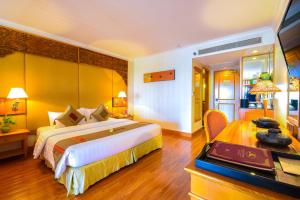 A bed or beds in a room at Angkor Century Resort & Spa