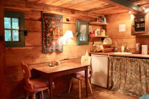 a wooden kitchen with a table and a sink at Le Cerf Volant in Adainville +31 photos