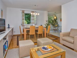 a kitchen and living room with a table and chairs at Spacious apartment in Dubrovnik with private garage in Dubrovnik