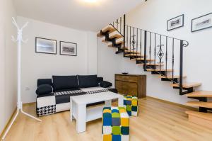 a living room with a couch and a staircase at Rooms Baza in Dubrovnik