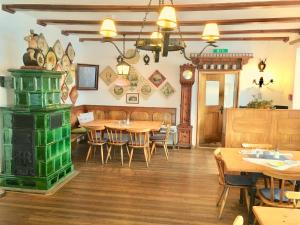 a restaurant with wooden tables and chairs and a clock at Hotel am See - Seeresidenz in Altaussee