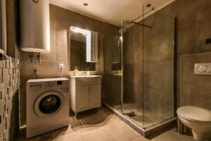 a bathroom with a washing machine and a shower at Apartments Amigo in Kotor