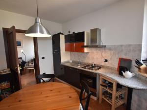 a kitchen with a table and a counter top at Belvilla by OYO La Torre in Belvedere Langhe