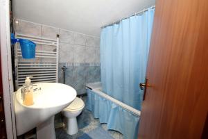 a bathroom with a sink and a toilet and a shower at Apartments Sersic in Baška +43 photos