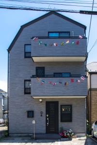 a house with flags on the side of it at Tokyo Aoto House in Tokyo