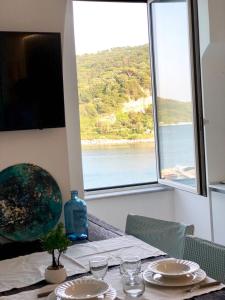 a dining table with a view of the water at Vongola in Portovenere