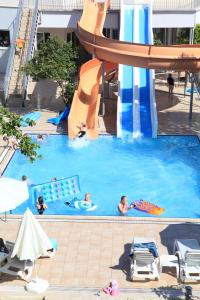 a group of people in a pool with a water slide at Catty Cats Garden Hotel in Side