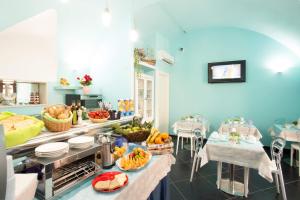a kitchen with a counter with fruits and vegetables on it at Relais Parallelo 41 in Vieste