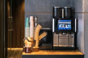 a counter top with a blender and a cup of coffee at HOTEL THE FLAG Shinsaibashi in Osaka