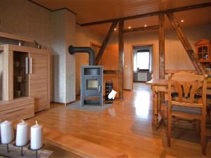 a living room with a wood stove and a table at Pleasant Apartment in Kierspe with Private Terrace in Kierspe