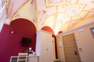 a room with a ceiling with paintings on it at Relais Parallelo 41 in Vieste