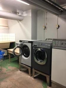 a laundry room with two washing machines in it at Central Stockholm with Free Airport Pickup in Stockholm