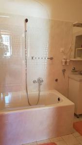 a bathroom with a bath tub with a shower at Mama's & Papa's house in Vrboska +46 photos