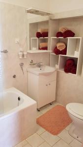 a bathroom with a sink and a toilet and a tub at Mama's & Papa's house in Vrboska