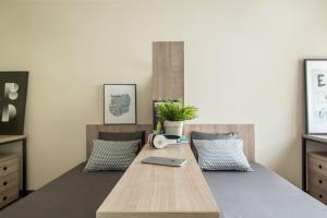 a bedroom with a bed with a laptop on it at Residencia Universitaria Hernan Cortes in Salamanca