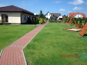 a brick path in a yard with a playground at luna in Gąski