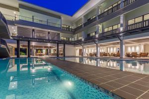 a large swimming pool in a large building at Camar Resort Langkawi in Pantai Cenang