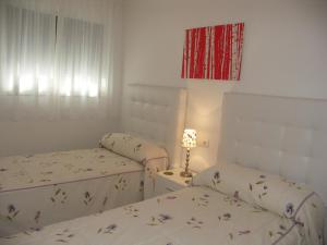 A bed or beds in a room at Apartamentos Plaza España