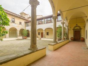 an empty courtyard with columns and a building at Fattoria di Maiano in Fiesole