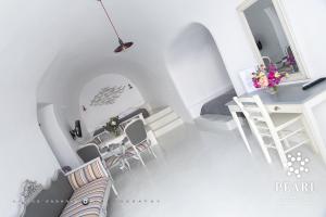 an overhead view of a living room with a table and chairs at Pearl on the Cliff Hotel & Suites by Pearl Hotel Collection in Imerovigli