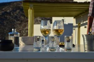 four glasses of wine sitting on a table at Vorina Ktismata in Amorgos