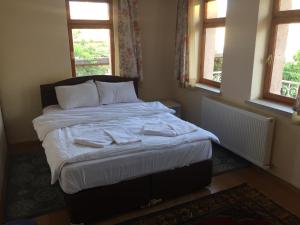 a bedroom with a bed with towels on it at Cappadocian Special House in Goreme