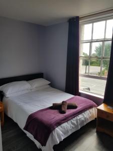 A bed or beds in a room at The Friar Tucks 