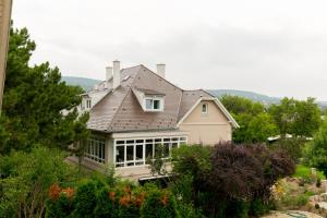 a large house with a gambrel roof at Manor House Inn Csopak in Csopak