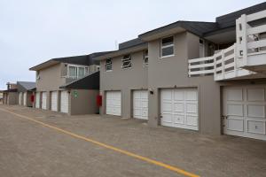 a row of garages with white garage doors at First Group Desert Rose in Hentiesbaai