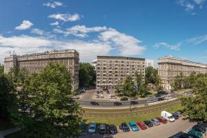 a parking lot with parked cars in front of buildings at Andersa Apartments in Warsaw