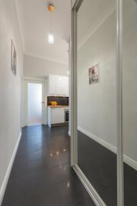 a hallway with a glass door leading to a kitchen at Andersa Apartments in Warsaw