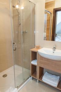 a bathroom with a shower and a sink at Villa Diana in Rozalin