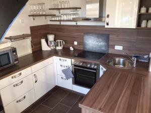 a kitchen with a sink and a stove top oven at Friesengut4 in Langeoog