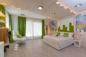 a bedroom with a white bed and a chair at Ca' de la Fonte - WENICE Deep Culture in Venice